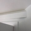 Installed Asheville Molding for Indirect Lighting shown above a doorway, creating a clean recessed ceiling transition in a residential interior.
