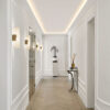 Installed New York 2-Step Crown Molding for LED's creating soft recessed ceiling illumination in a refined contemporary hallway.