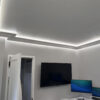 Installed New York 2-Way Molding for Indirect Lighting creating soft perimeter ceiling illumination in a contemporary interior.