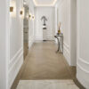Installed New York Baseboard Molding adding a crisp architectural finish along the walls of an elegant contemporary hallway.