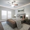 Installed Extra Tall Miami Art-Deco Baseboard adding elegant decorative trim details along the walls of a refined bedroom interior.